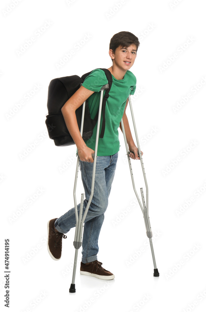Teenage boy with injured leg using crutches on white background Teenage boy with injured leg using crutches on white background