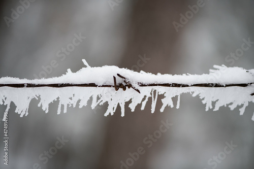 Metal wires covered with frost snow and snowflakes