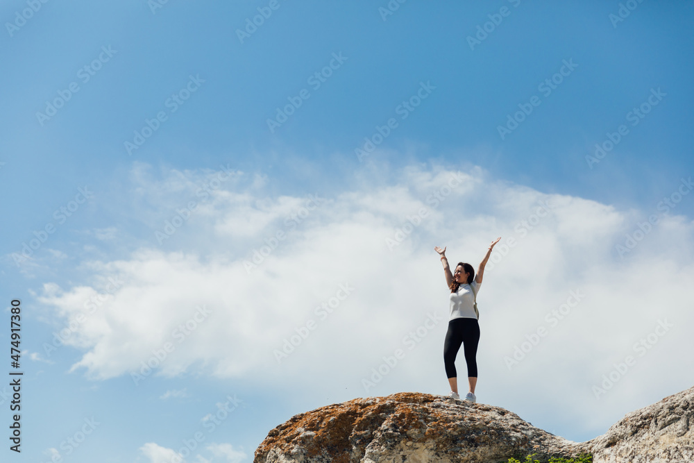 tourist woman traveler on top of a mountain alone looks at the landscape tourist woman traveler on top of a mountain alone looks at the landscape