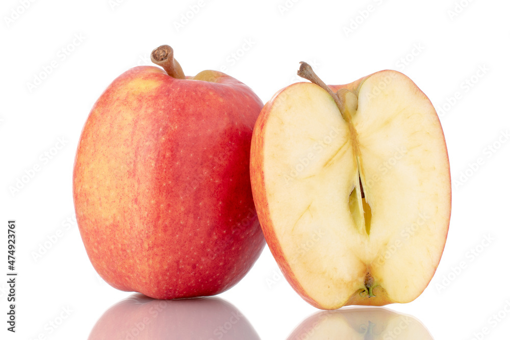 One half and one whole organic red apples, close-up, isolated on white. One half and one whole organic red apples, close-up, isolated on white.