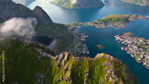 Fototapeta Naklejka Na Ścianę i Meble -  Amazing nature of Lofoten Islands, Norway By Drone top view  surrounded by norway sea green traditional district in the county of Nordland breathtaking scandinavian soccer mountain rock architecture