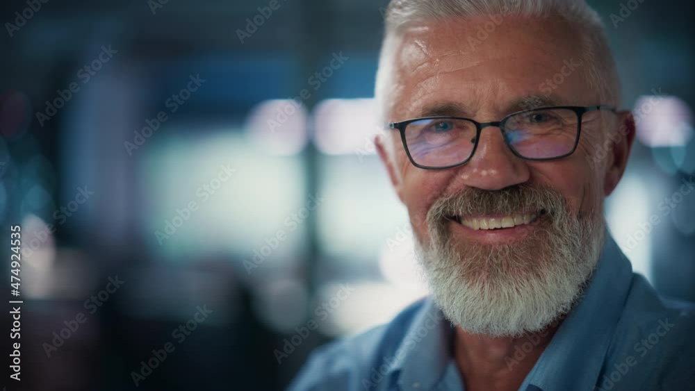 Portrait of Successful Middle Aged Bearded Man Looking at Camera and Smiling. Handsome Senior Businessman Wearing Jacket Rising Eyes, Having Fun. Slow Motion Medium Close-up Shot Portrait of Successful Middle Aged Bearded Man Looking at Camera and Smiling. Handsome Senior Businessman Wearing Jacket Rising Eyes, Having Fun. Slow Motion Medium Close-up Shot