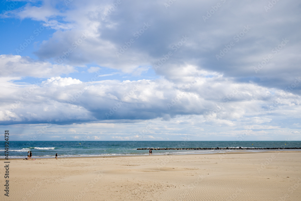 The fine sand beach of the city of Agde in Europe, France, Occitanie, Herault, in summer, on a sunny day.