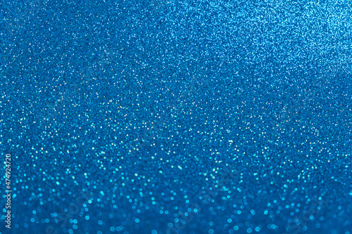 An abstract blue background with sparkle lights and bokeh.