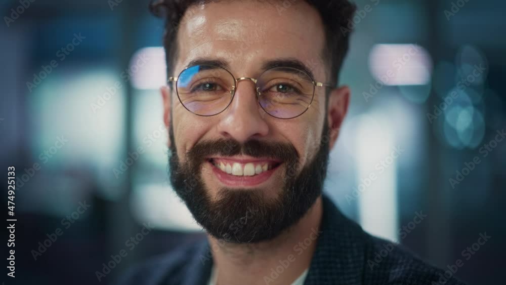 Portrait of Handsome Man with Deep Brown Eyes, Wearing Stylish Glasses. Shows Warm, Kind, Charming Smile. Attractive Modern Gentleman Looks at the Camera. Close-up Bokeh Background Portrait of Handsome Man with Deep Brown Eyes, Wearing Stylish Glasses. Shows Warm, Kind, Charming Smile. Attractive Modern Gentleman Looks at the Camera. Close-up Bokeh Background