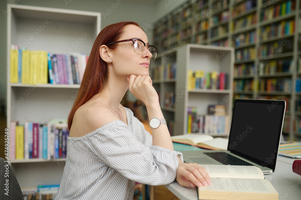 Pensive woman with open book looking to side Pensive woman with open book looking to side