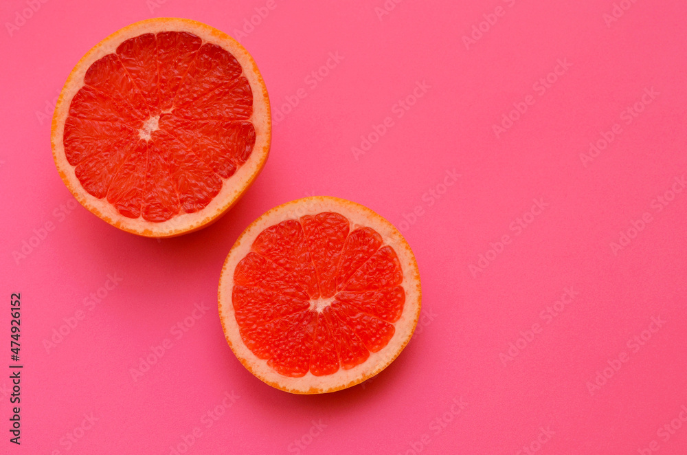 bright image slice of red grapefruit on a pink background close up bright image slice of red grapefruit on a pink background close up