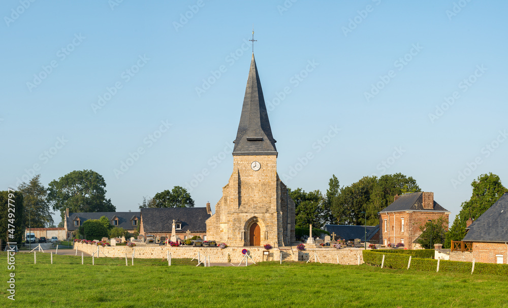 The church in the middle of the traditional French village of Saint Sylvain in Europe, France, Normandy, Seine Maritime, in summer on a sunny day.