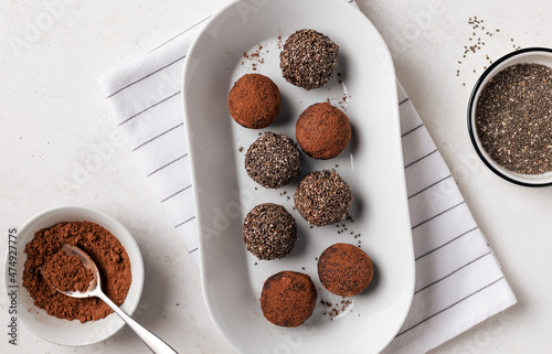 Photography dates, chia seeds and cacao bliss balls on white plate