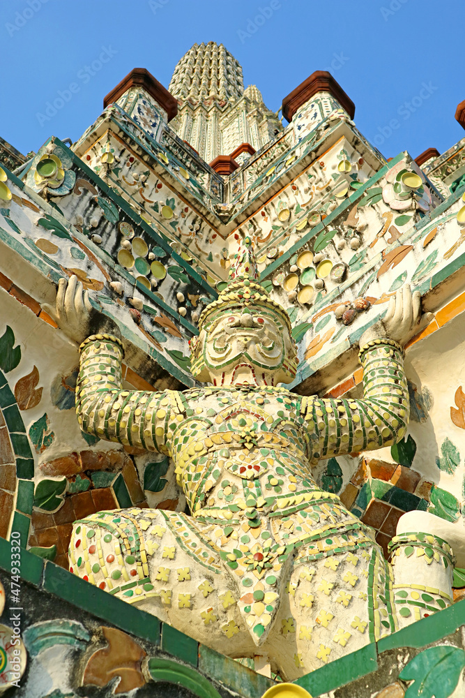Fototapeta premium Amazing Architectural Details of the Main Prang of Wat Arun with Mythical Yaksha Demon Sculptures and Pieces of Chinese Porcelain, Bangkok, Thailand 