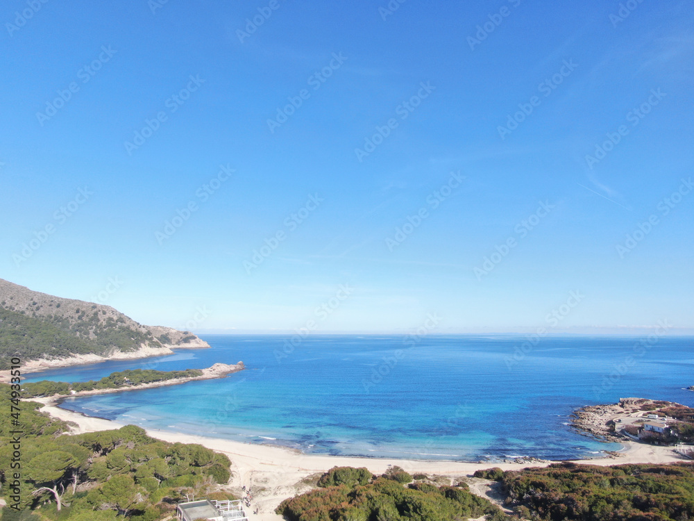 Cala Agulla Mallorca. Aerial view of the seacoast of the beach in Mallorca with torquoise water colour. Amazing photo of the beach. Concept of summer, travel, relax and holiday and vacation