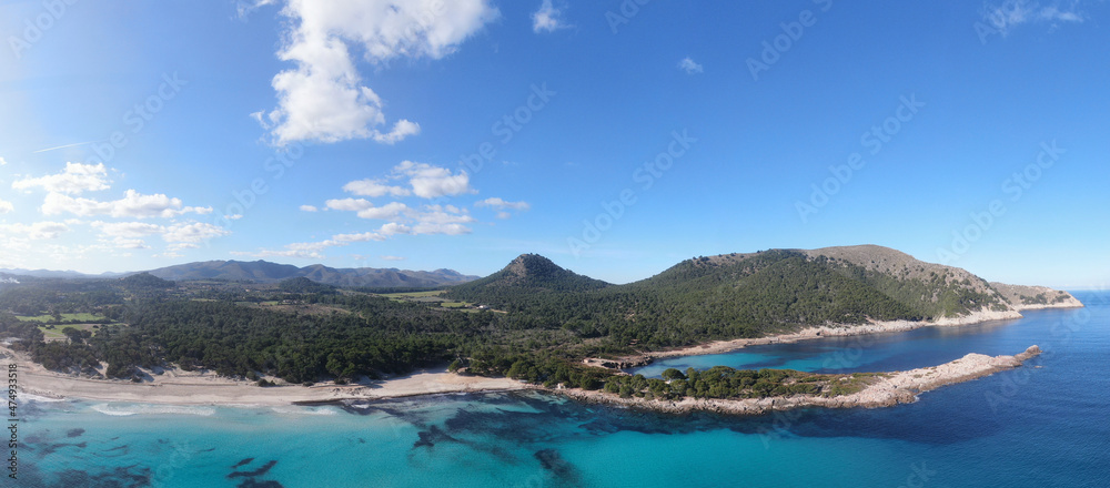 Panoramic photo of Cala Agulla  beach in Mallorca. Beautiful view of the seacoast of Mallorca with an amazing turquoise sea, in the middle of the nature. Concept of summer, travel, relax and enjoy.