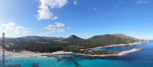 Panoramic photo of Cala Agulla beach in Mallorca. Beautiful view of the seacoast of Mallorca with an amazing turquoise sea, in the middle of the nature. Concept of summer, travel, relax and enjoy.