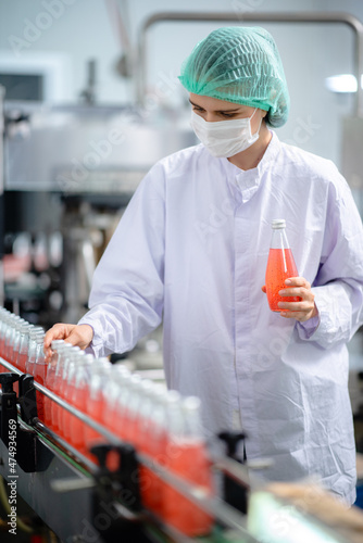 food technician control checking production line of water drink in manufacturing factory