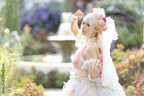 Beautiful young woman with white lolita dress with flowers garden Japanese fashion
