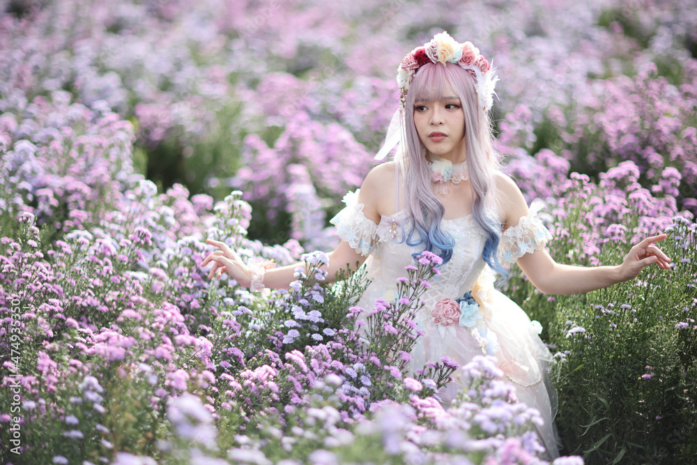 Fototapeta premium Beautiful young woman with white lolita dress with flowers garden Japanese fashion