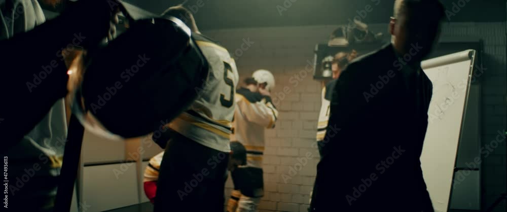 Angry disappointed coach yelling on players of ice hockey team as they entering the locker room during the intermission. Shoot with 2x anamorphic lens Angry disappointed coach yelling on players of ice hockey team as they entering the locker room during the intermission. Shoot with 2x anamorphic lens