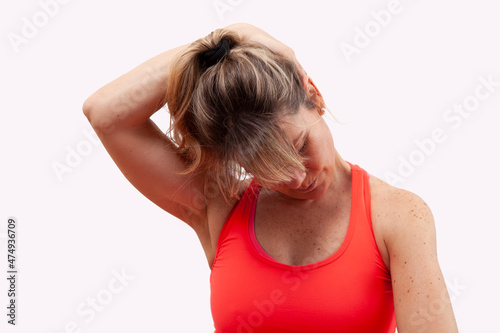 middle-aged woman doing cervical stretching on white background