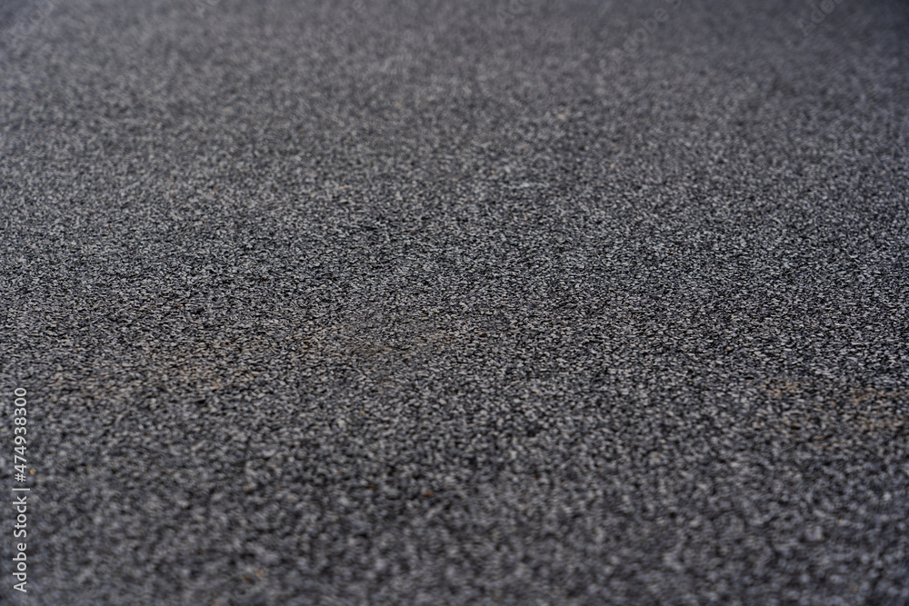 Rubber floor black texture background. Black rubber crumb coating on the sports field. selective focus Rubber floor black texture background. Black rubber crumb coating on the sports field. selective focus