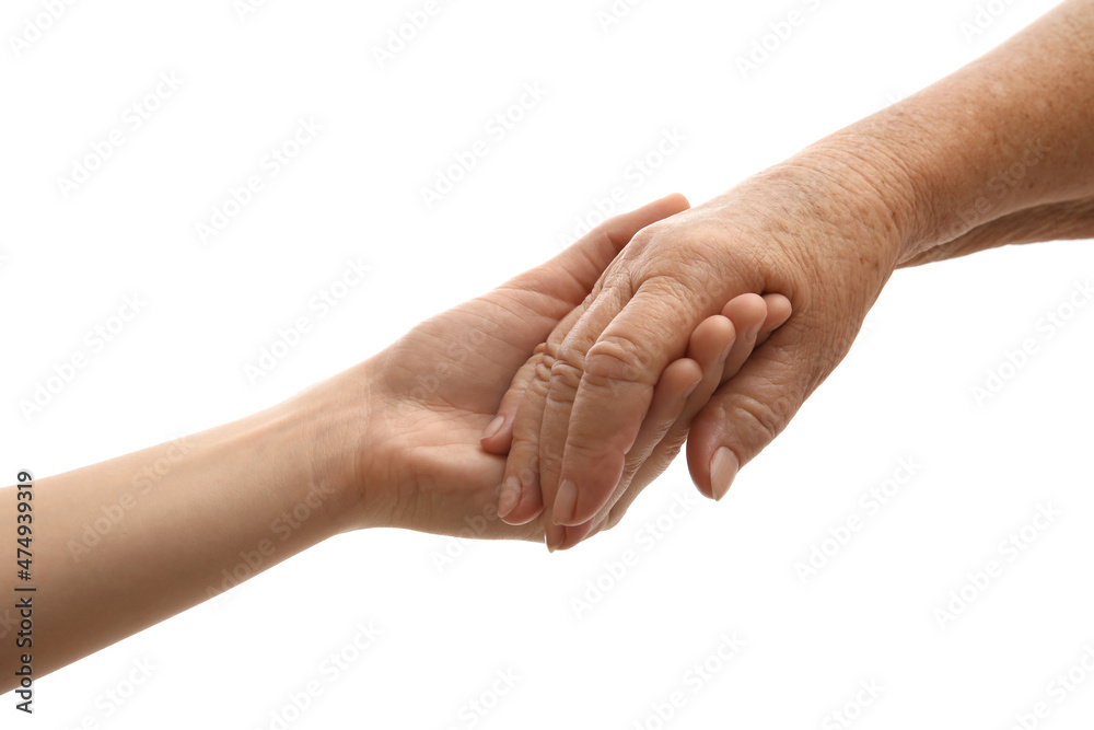 Young and elderly women holding hands together on white background, closeup Young and elderly women holding hands together on white background, closeup