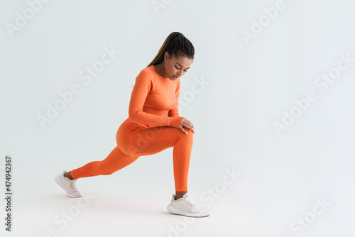 Black young sportswoman doing exercise while working out