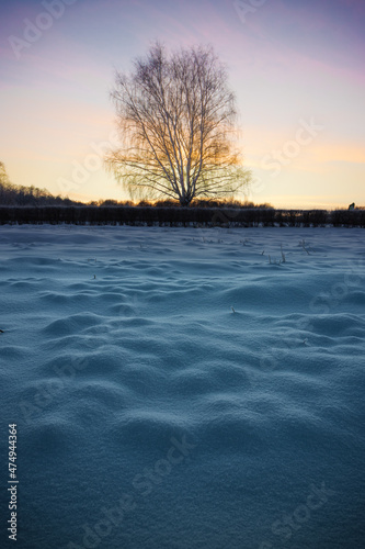 sunset over the snowy field in the Izmailovsky park, Moscow, Russia