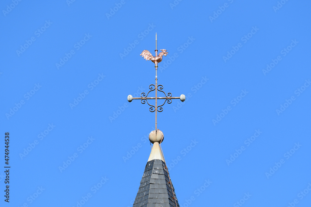 The bronze rooster on the steeple of Cuncy les Varzy in Europe, France, Burgundy, Nievre, in summer, on a sunny day. The bronze rooster on the steeple of Cuncy les Varzy in Europe, France, Burgundy, Nievre, in summer, on a sunny day.
