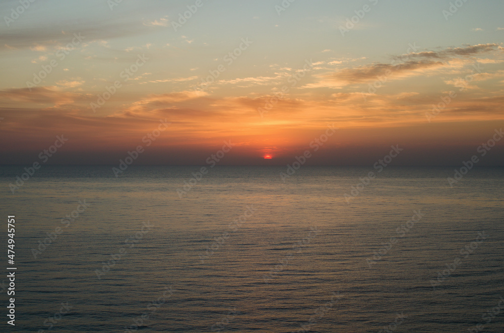 The sun's disk rises over the sea horizon. The Mediterranean Sea near Mersin, Turkey. Travel and tourism concept