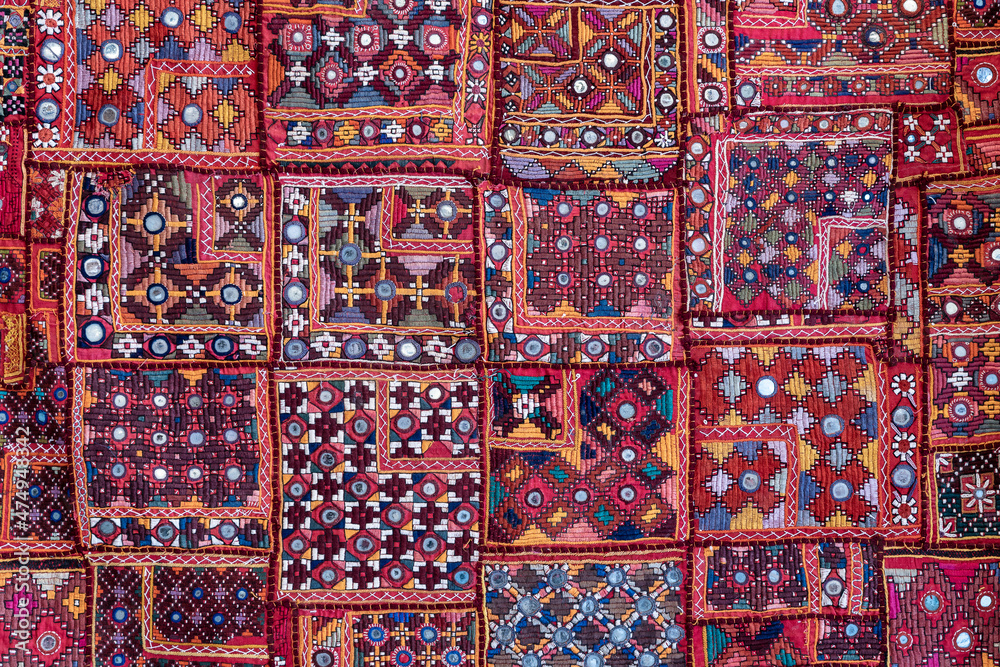 Detail old colorful patchwork carpet in India. Close up