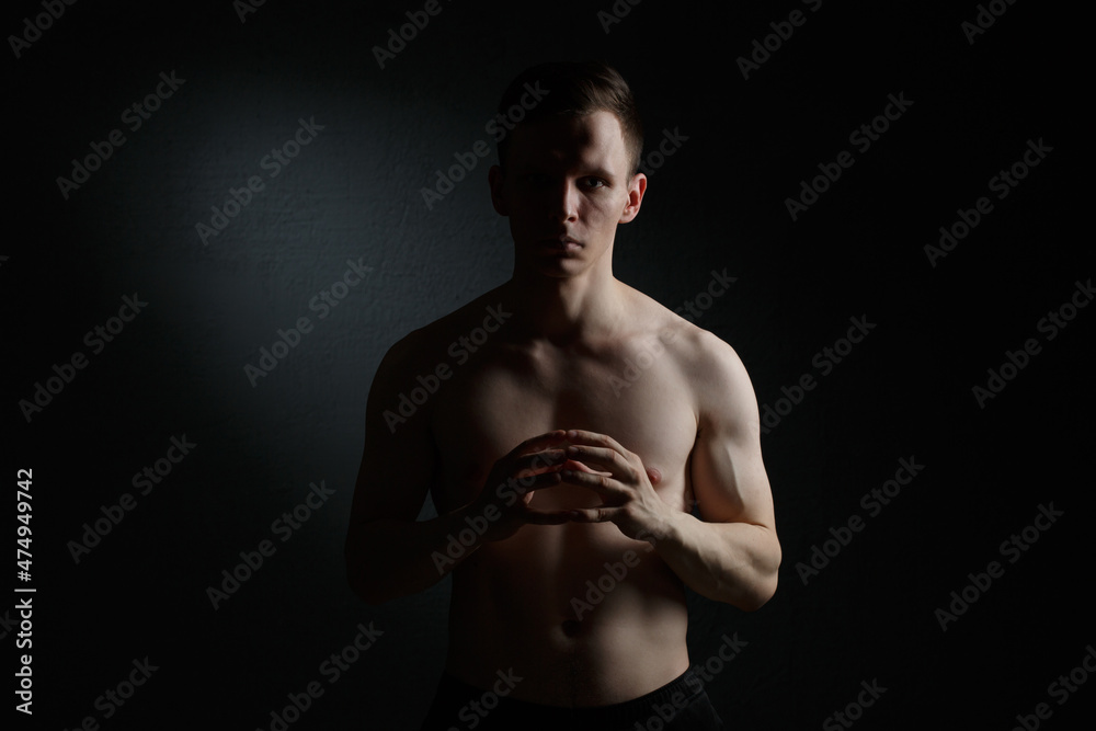 Athletic guy on a black background.