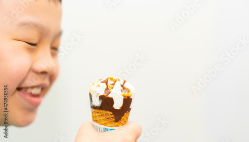 kid eating ice cream wafer cone with happiness