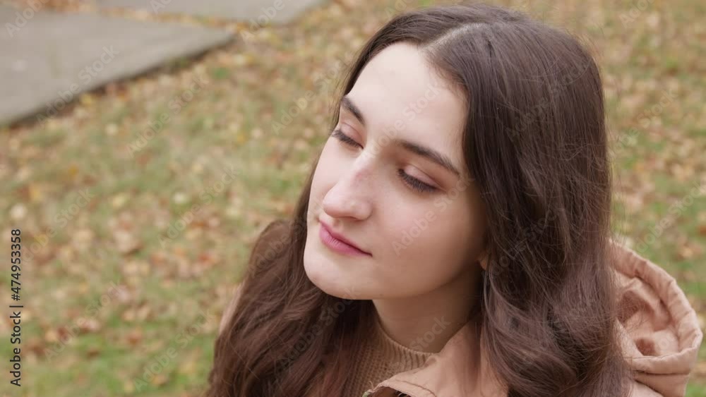 The face of a relaxing and happy young Hispanic woman sitting on the street. The face of a relaxing and happy young Hispanic woman sitting on the street.