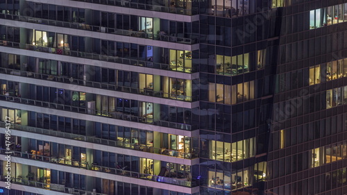 Windows lights in modern office and residential buildings timelapse at night