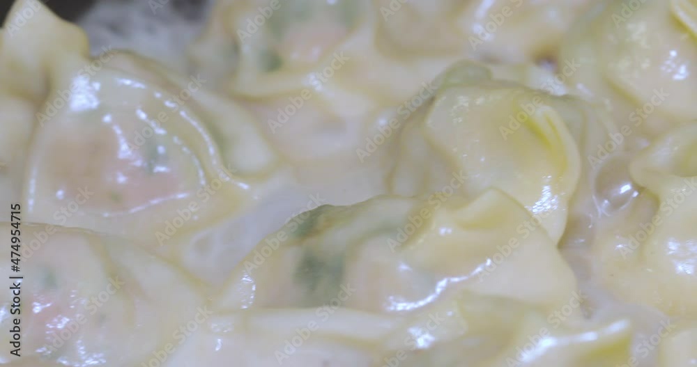 Fried dumplings are being cooked in the hot frying pan Fried dumplings are being cooked in the hot frying pan