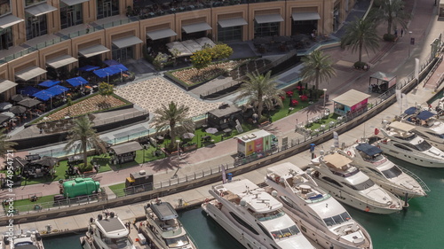 Принти на полотні Dubai marina promenade on waterfront along canal aerial timelapse