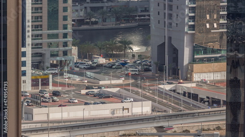 Car parking for light vehicles and road traffic in Dubai JLT luxury residential district aerial view timelapse