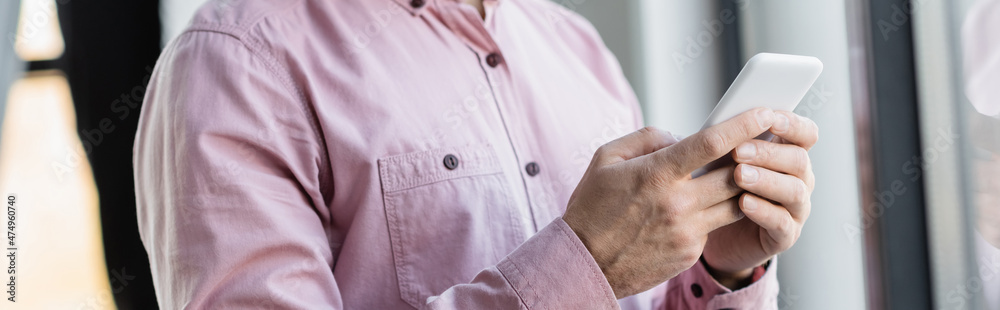 Cropped view of businessman using mobile phone in office, banner. Cropped view of businessman using mobile phone in office, banner.