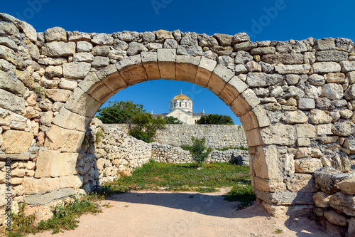 Fototapeta Naklejka Na Ścianę i Meble -  The ruins of the ancient city against the background of an Orthodox church.