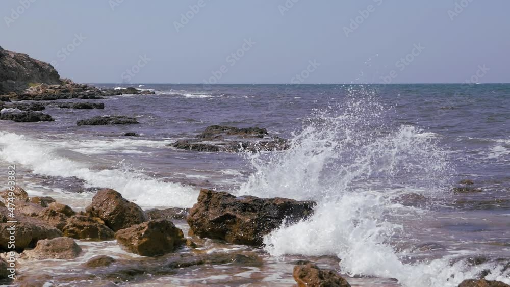 Sea waves break on the coastal rocks. Sea waves break on the coastal rocks.
