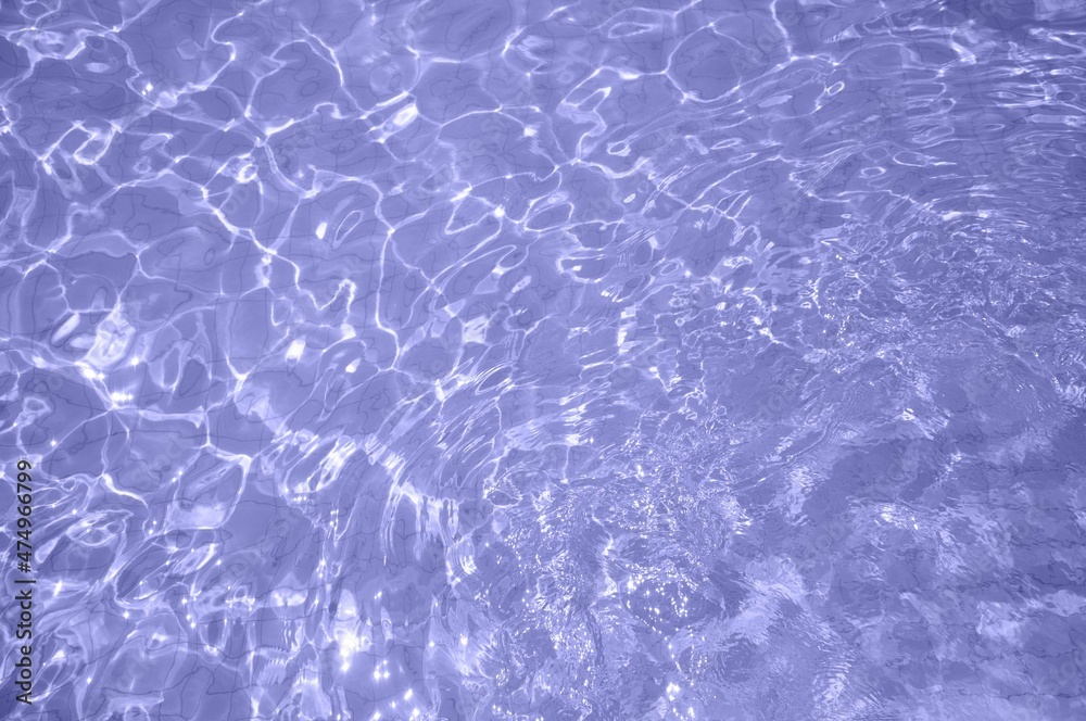 Very peri color of the year 2022. Trendy concept. Swimming pool bottom caustics ripple and flow with waves background. Very peri color of the year 2022. Trendy concept. Swimming pool bottom caustics ripple and flow with waves background.