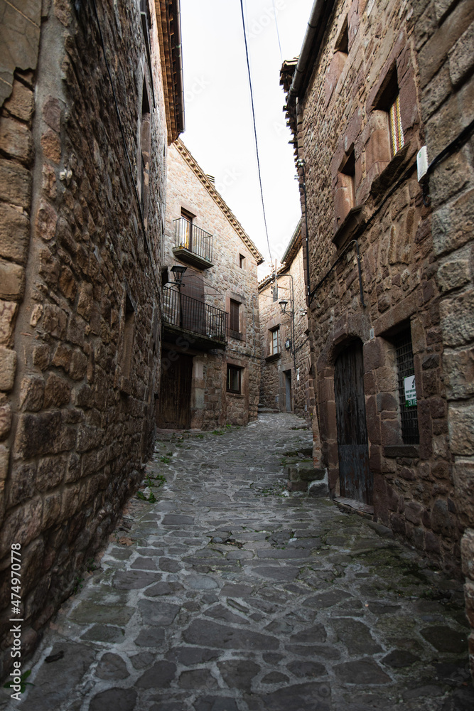Old narrow medieval street in Catalonian village L'Estany, Spain