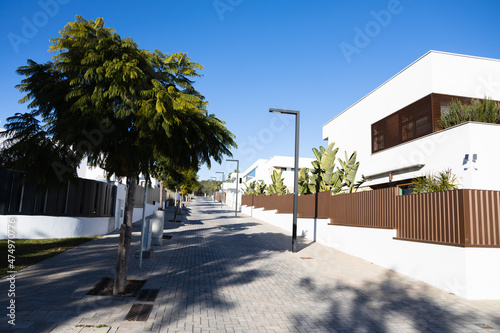 Modern minimalist white house exterior, street with new houses, Sitges, Spain