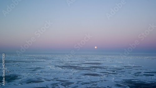 moon above the horizon at the north pole