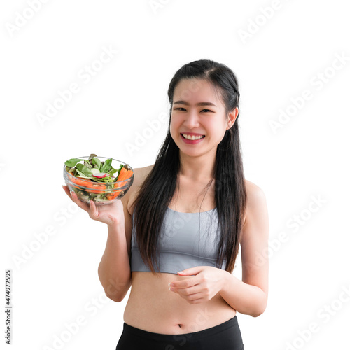 Portrait of happy healthy Asian woman in sportswear standing smiling and holding salad bowl in the kitchen at home isolated on white background with clipping path.