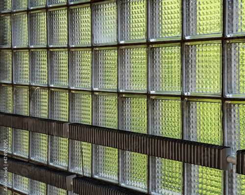 Transparent glass wall blocks with a green tint, stacked in the wall