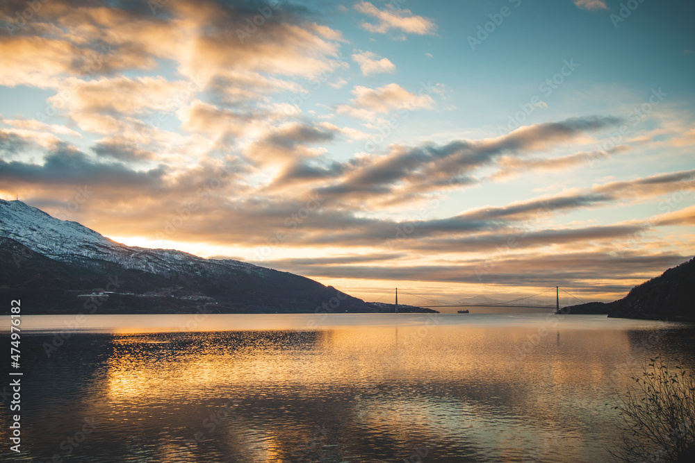 Beautiful dramatic sunset overlooking Lake Rombaken and the Halogaland Bridge that connects Narvik to the rest of Norway. Northern Norway under the last rays of light