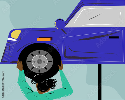 Woman mechanic changing a tire on the car 
