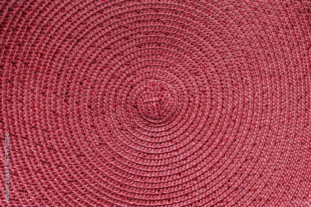 abstract background of round pink straw mat with glitter thread close up abstract background of round pink straw mat with glitter thread close up