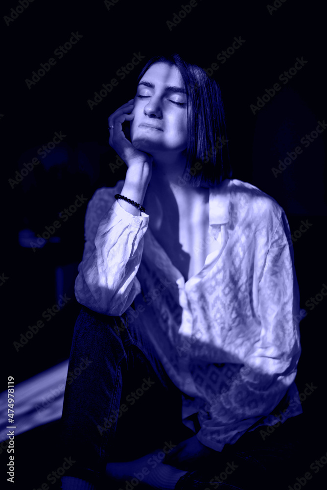 Beauty portrait of a beautiful young girl with a shadow pattern on the face and body in the form of stripes. very peri colored. Color of the year 2022 Beauty portrait of a beautiful young girl with a shadow pattern on the face and body in the form of stripes. very peri colored. Color of the year 2022