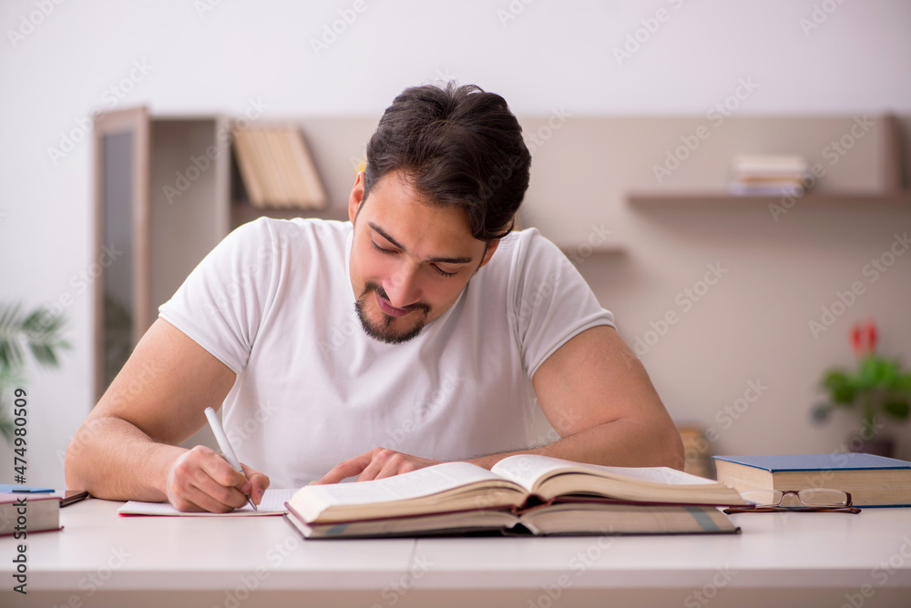 Young male student studying at home during pandemic Young male student studying at home during pandemic